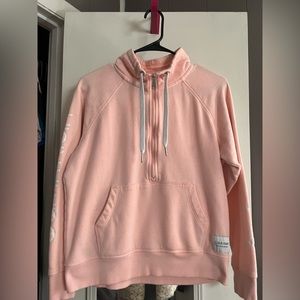 Calvin Klein pullover in peachy pink. Size is small.